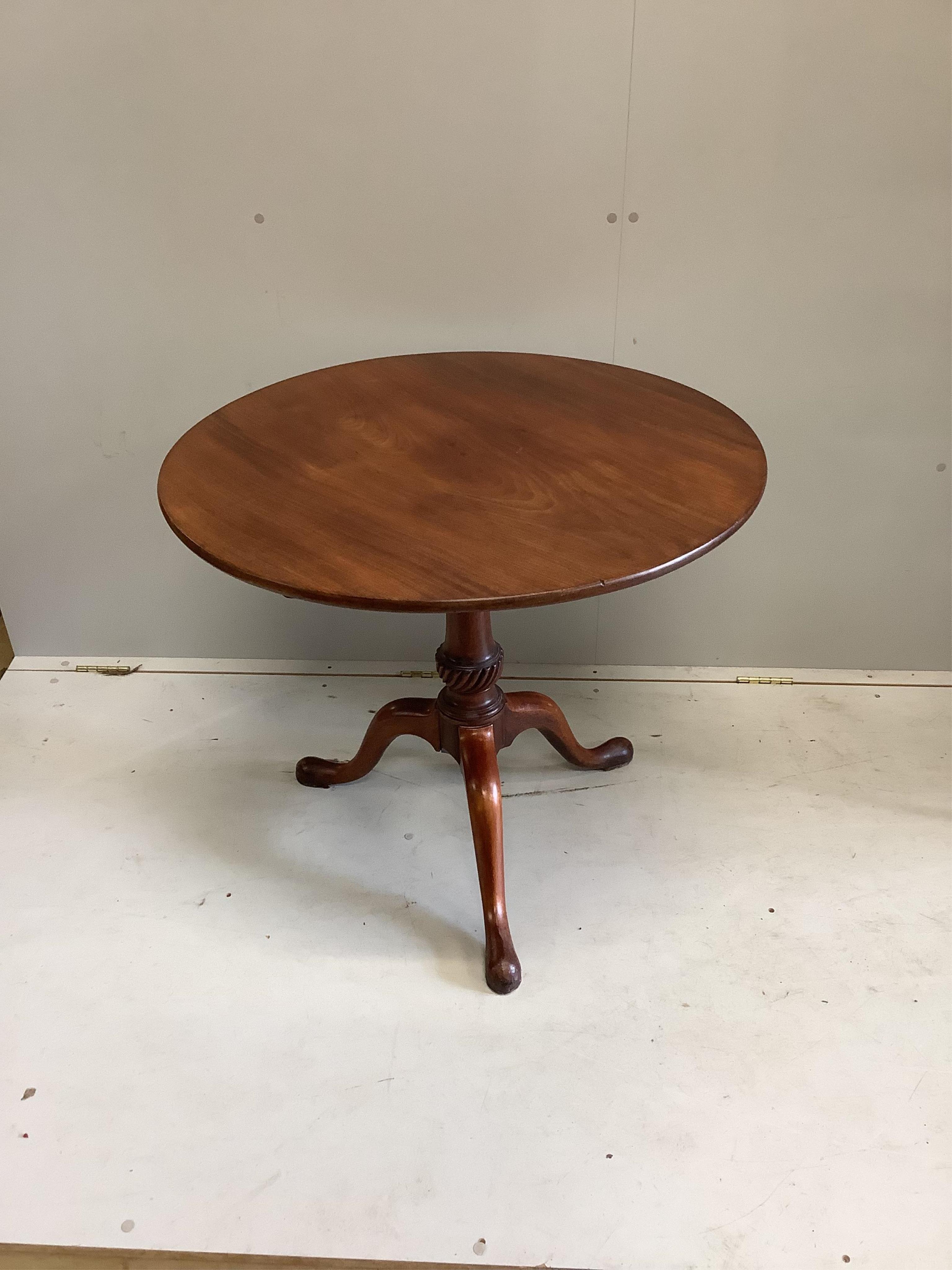 A George III circular mahogany tilt top bird cage tripod tea table, diameter 82cm, height 71cm. Condition - fair